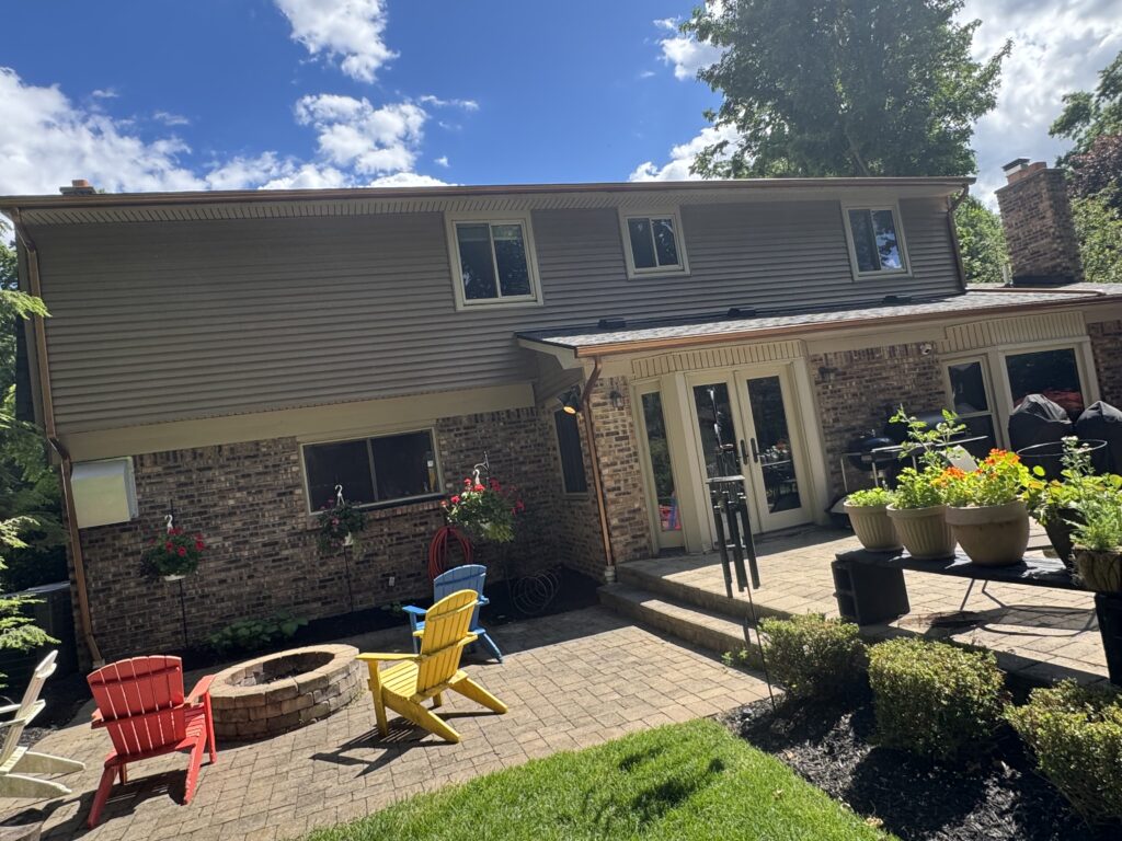 Black six-inch seamless gutters installed on a home
